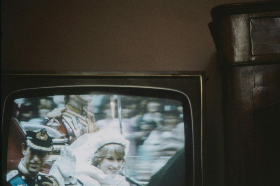 people watching tv together in 80s living room